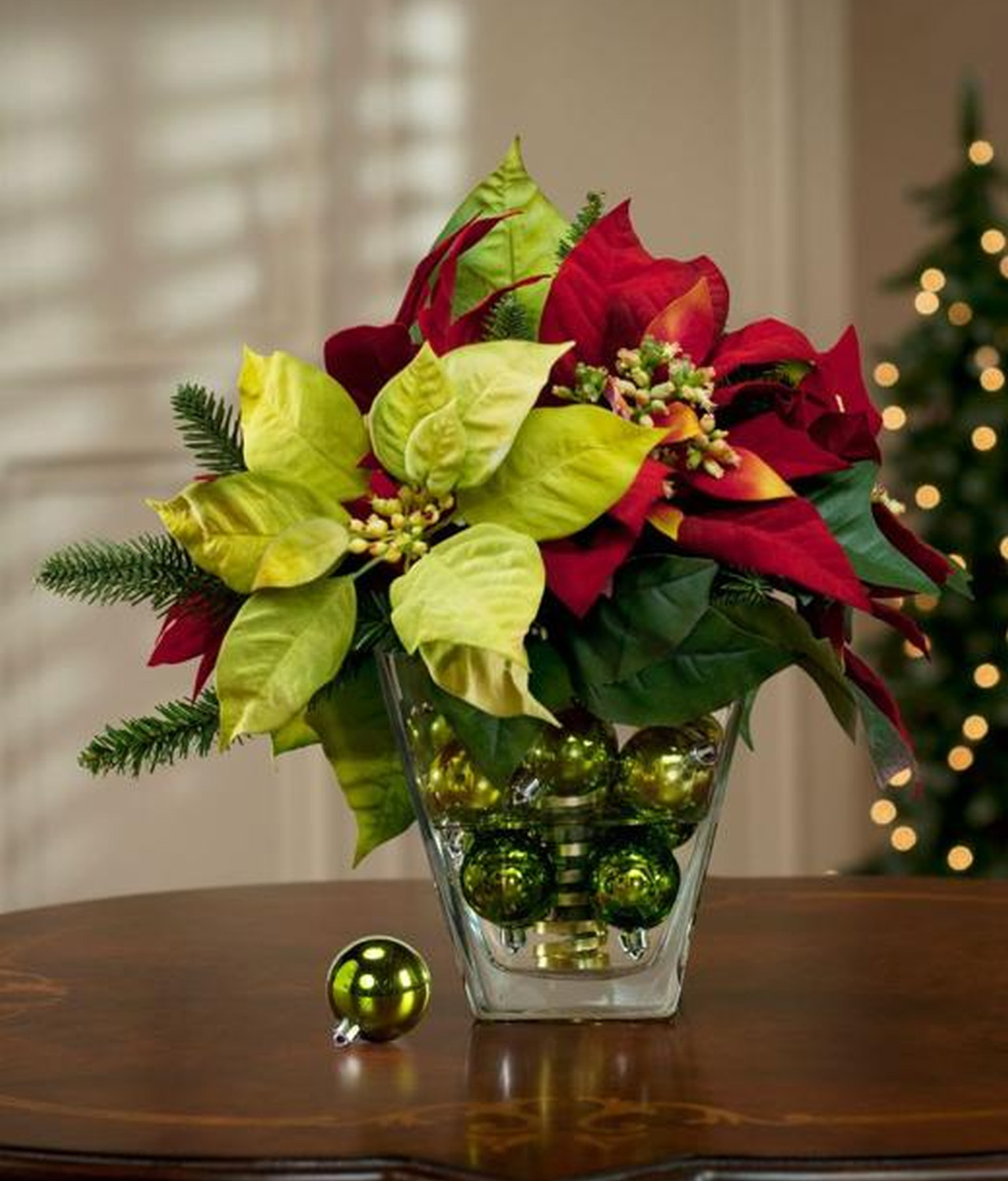 Poinsettia bouquet in a glass jar with Christmas baubles