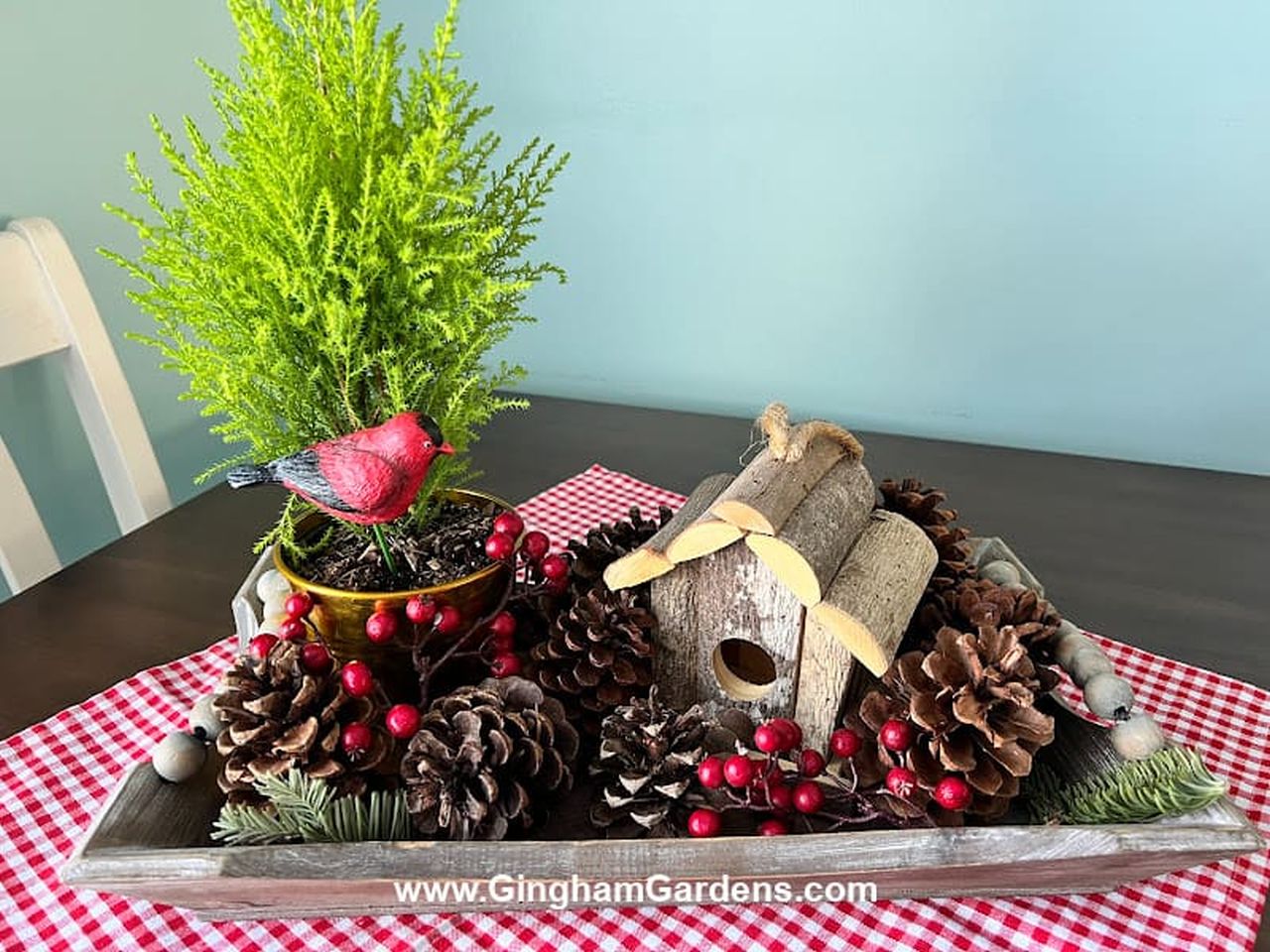 Table centerpiece with pines and wood logs