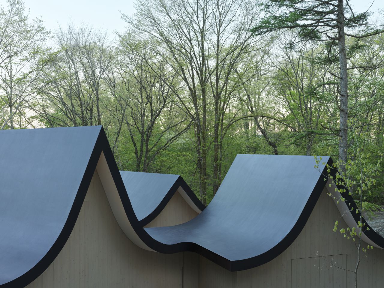 Nendo Builds Weekend House that Consists of Six Cottages, Intertwined With a Terrace and Roof - curved roof design