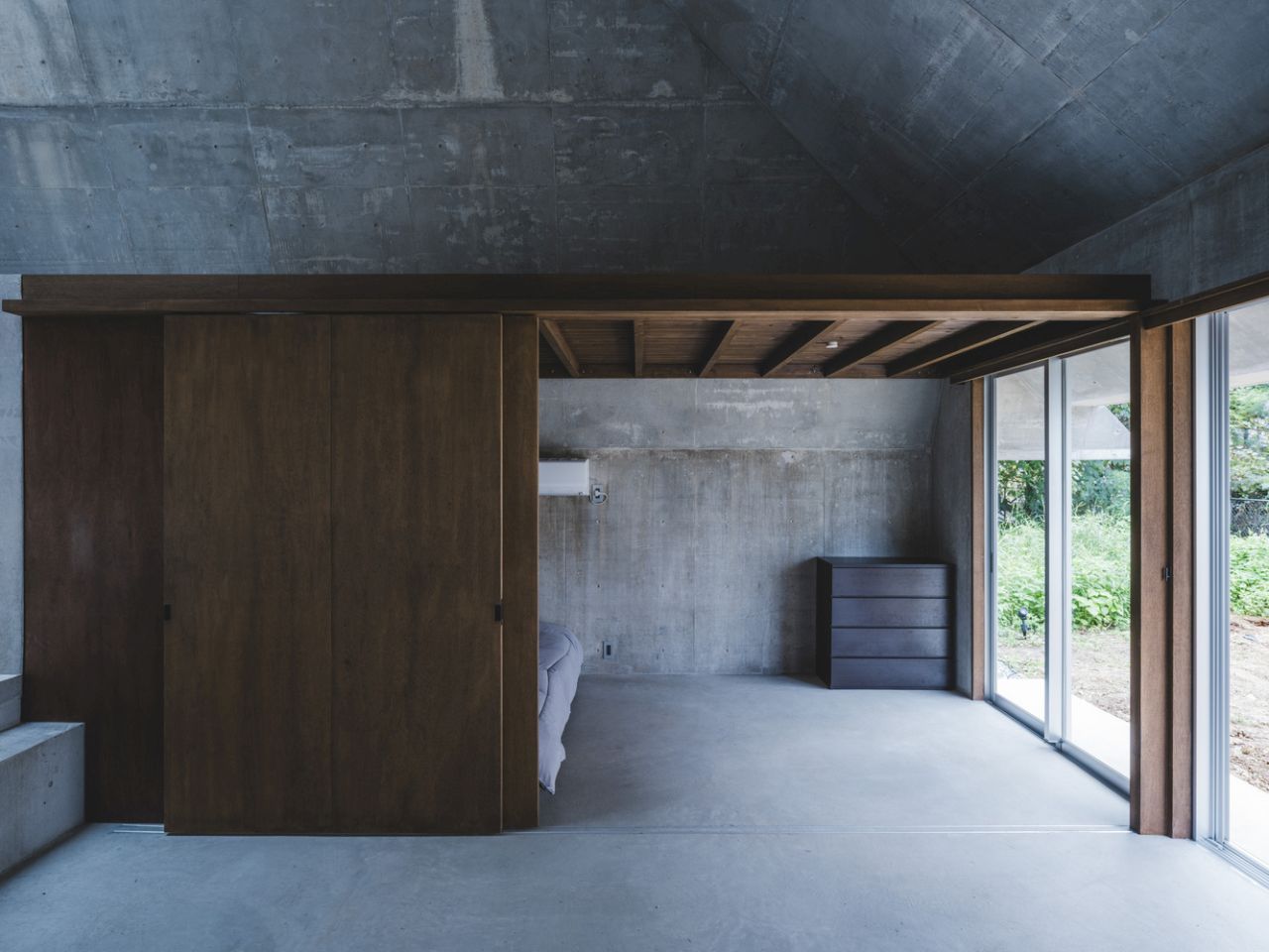 This Concrete House in Japan Embraces a Pyramid Shape to Adapt to its Sloping Site