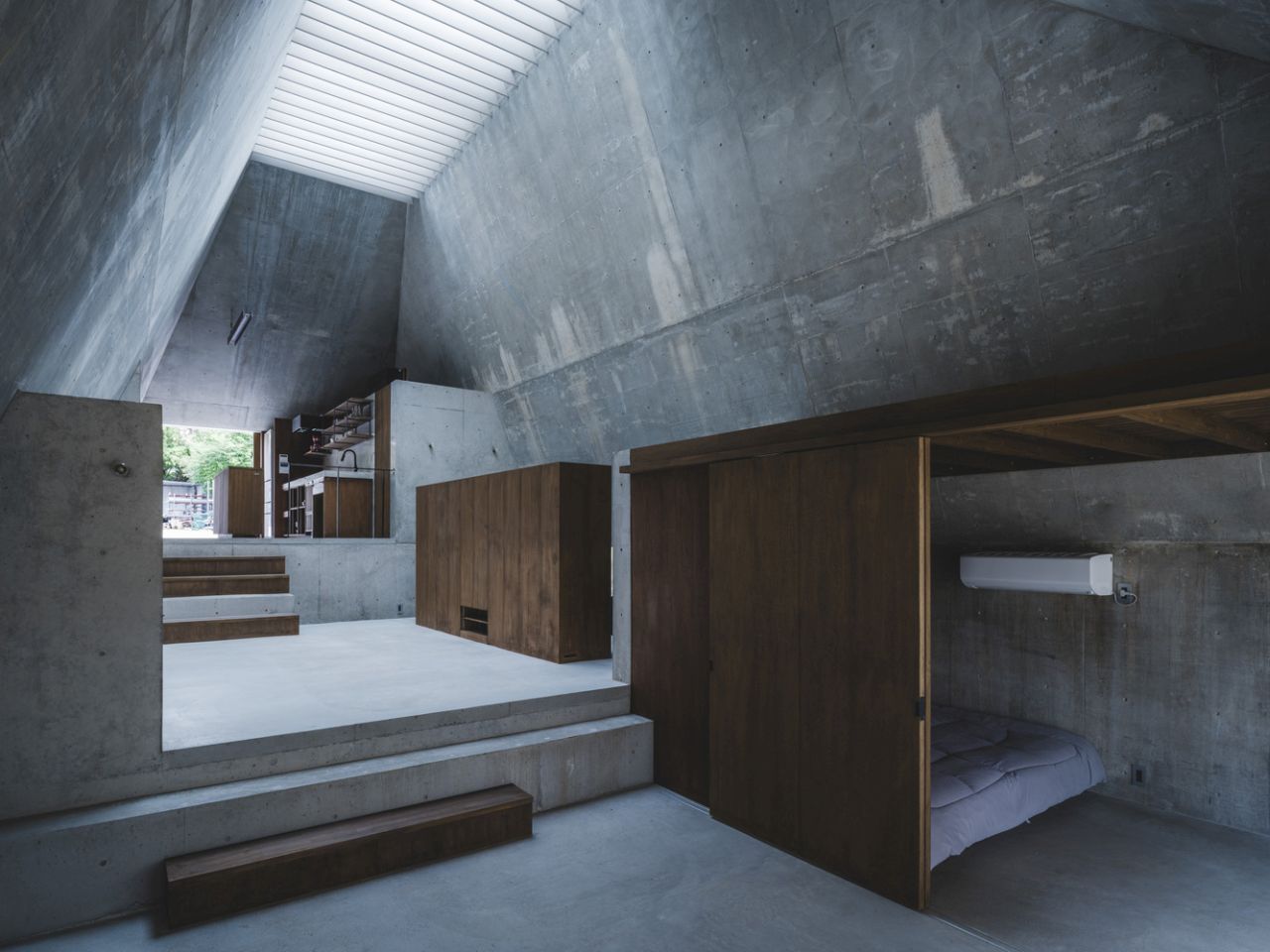 This Concrete House in Japan Embraces a Pyramid Shape to Adapt to its Sloping Site