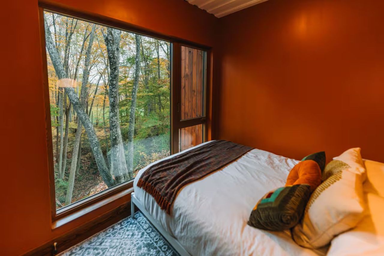 This Tiktok-Famous Shipping Container Cabin in Ohio Perches Over a Waterfall