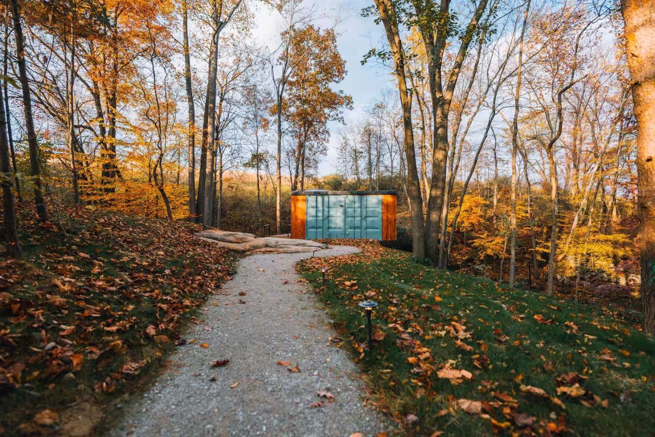 This Tiktok-Famous Shipping Container Cabin in Ohio Perches Over a Waterfall