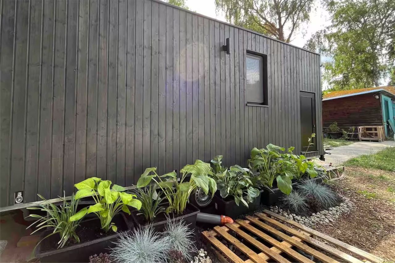 This Tiny House Features a Wide Corner Sofa That Doubles as Bed in Night