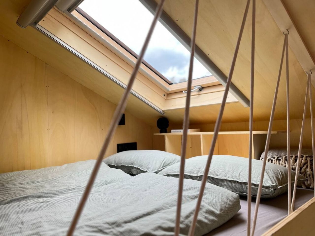 This Tiny House Features a Wide Corner Sofa That Doubles as Bed in Night