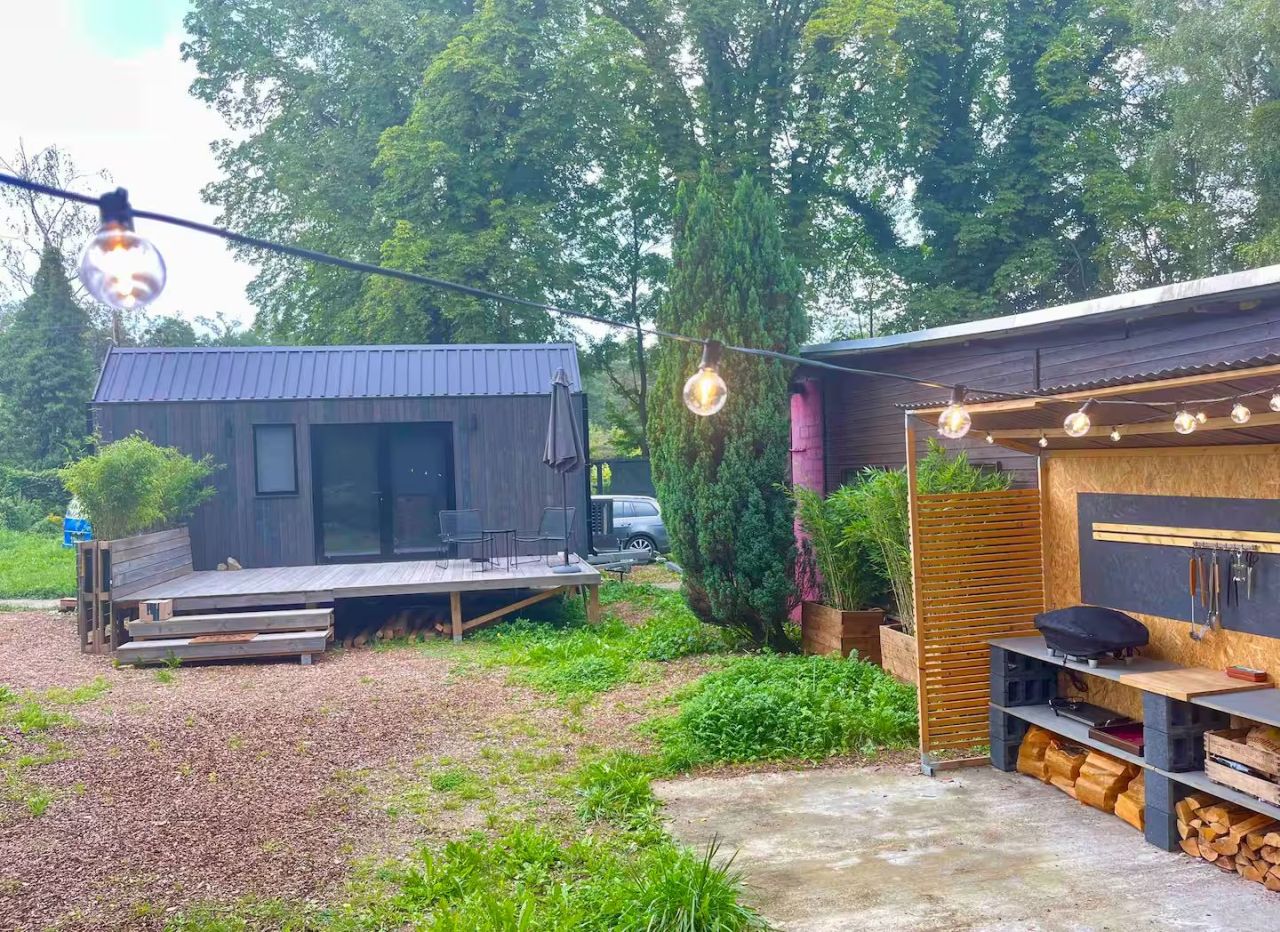 This Tiny House Features a Wide Corner Sofa That Doubles as Bed in Night