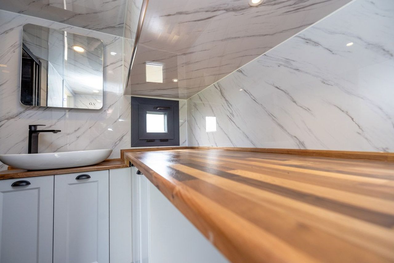 This Tiny House with Two Separate Loft Bedrooms is Suitable for Families