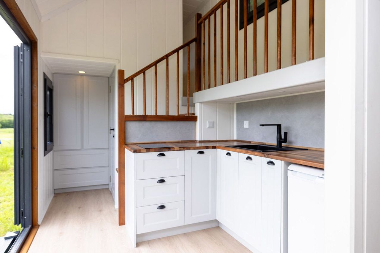 This Tiny House with Two Separate Loft Bedrooms is Suitable for Families