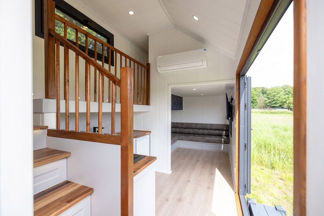 This Tiny House with Two Separate Loft Bedrooms is Suitable for Families