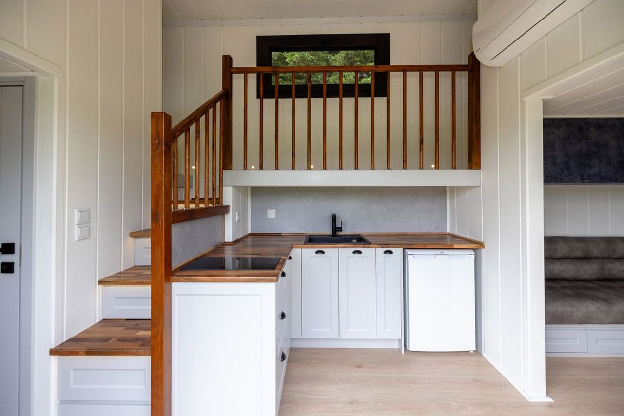 This Tiny House with Two Separate Loft Bedrooms is Suitable for Families