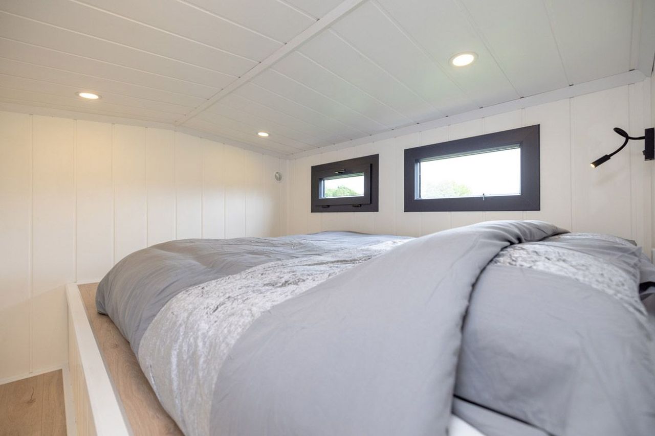 This Tiny House with Two Separate Loft Bedrooms is Suitable for Families