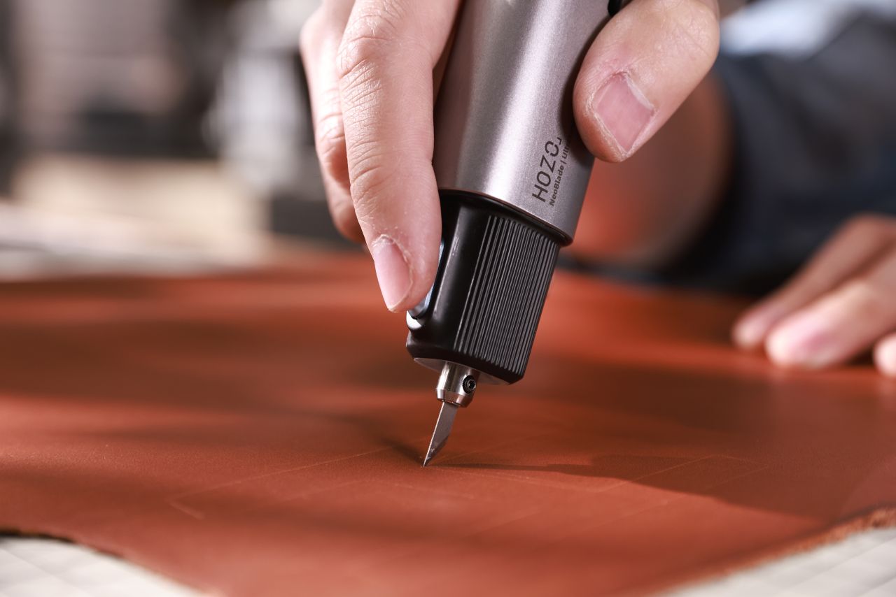 NeoBlade Wireless Ultrasonic Cutter - cutting through leather