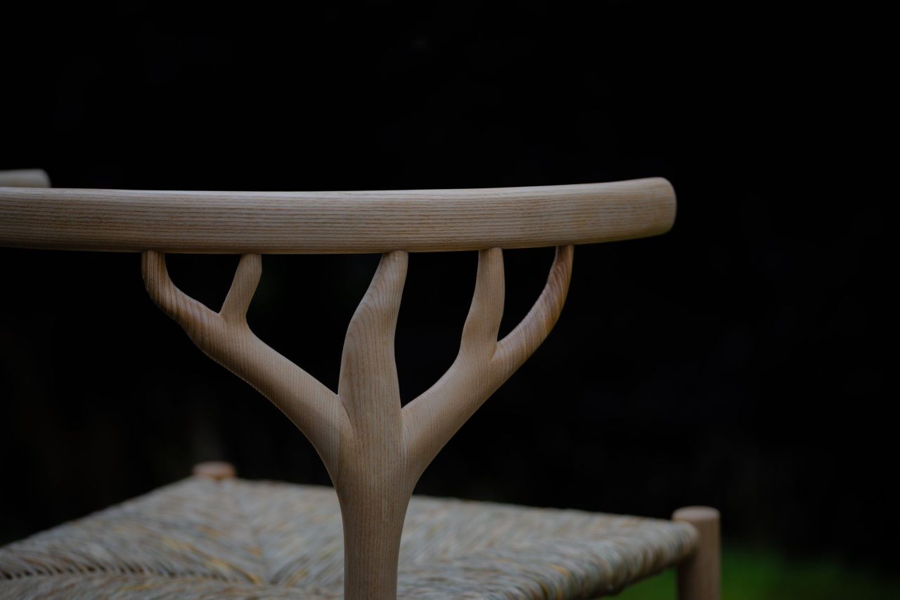 The Marchmont Workshop Canopy Chair Features Hand-Woven Rush Seat and Antler-Shaped Backrest