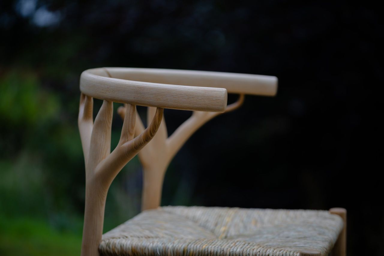 The Marchmont Workshop Canopy Chair Features Hand-Woven Rush Seat and Antler-Shaped Backrest