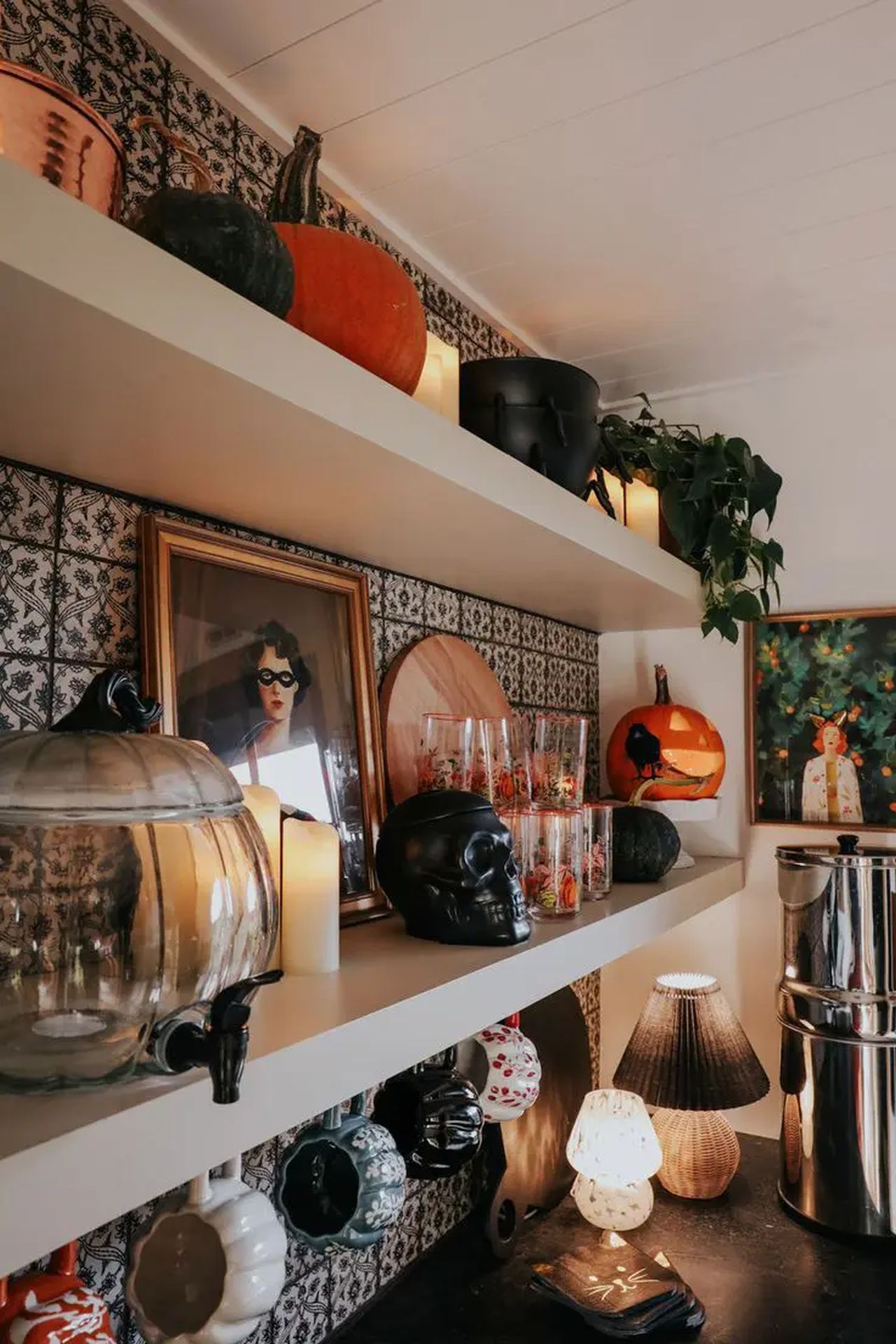 Kitchen shelves done with black skulls, black and orange pumpkins