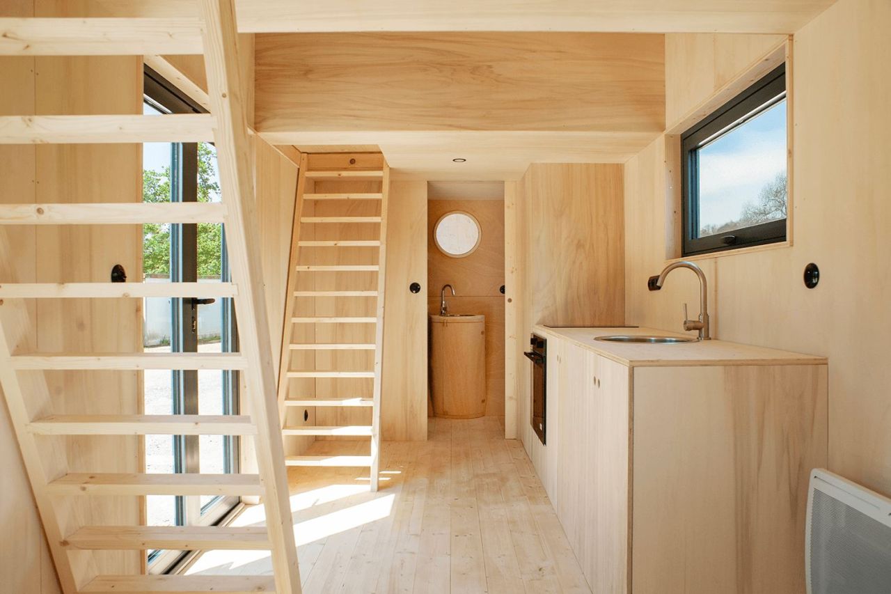 This French Tiny House on Wheels is Defined by its Porthole Windows and Vertical Silhouette