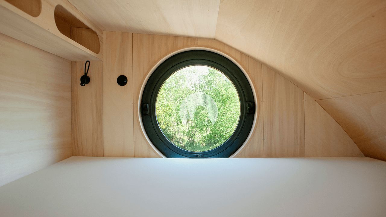 This French Tiny House on Wheels is Defined by its Porthole Windows and Vertical Silhouette