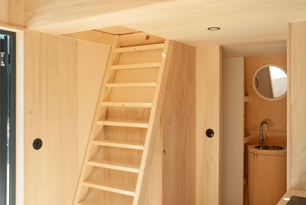 This French Tiny House on Wheels is Defined by its Porthole Windows and Vertical Silhouette