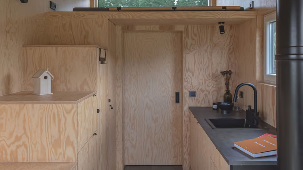 The mezzanine loft has stairs with inbuilt storage and bathroom   next to it.