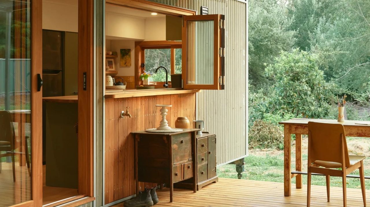 Spacious kitchen has bifold window that makes it easy to access it from porch