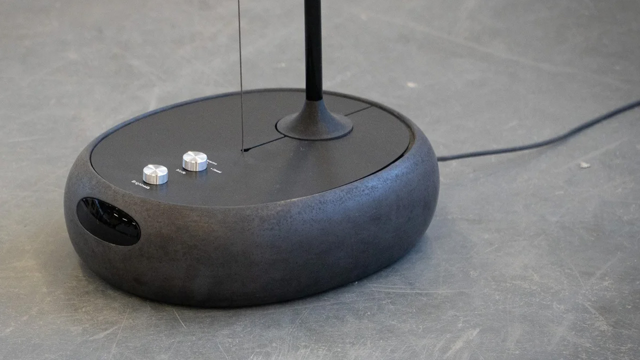 A compact base that has buttons to adjust the light or keep the lamp open.