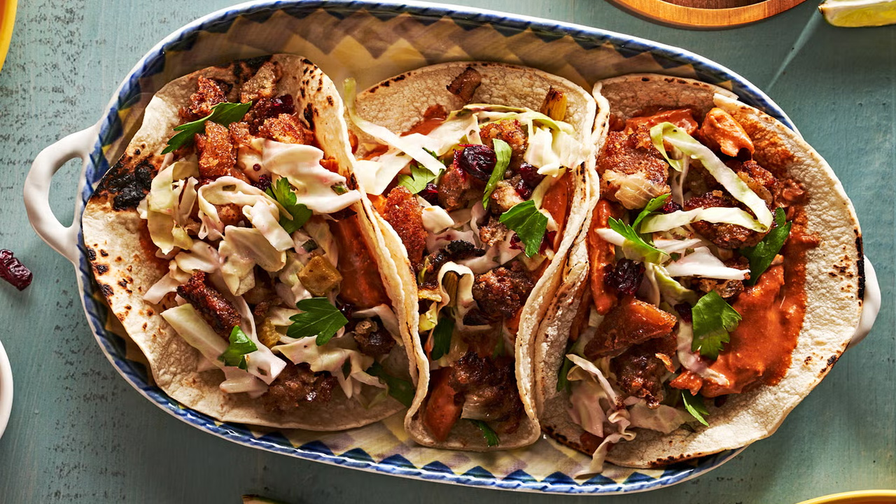 Leftovers drizzled with rich sauce, all wrapped in warm, lightly charred tortillas