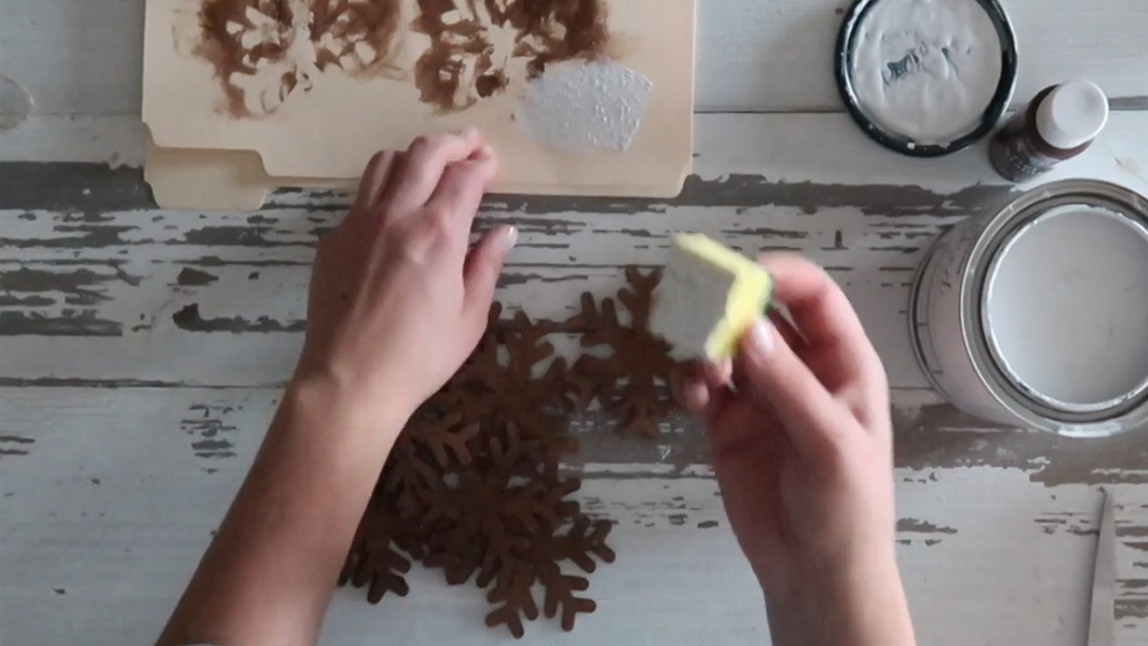 Remove the excess paint before dabbing the snowflake