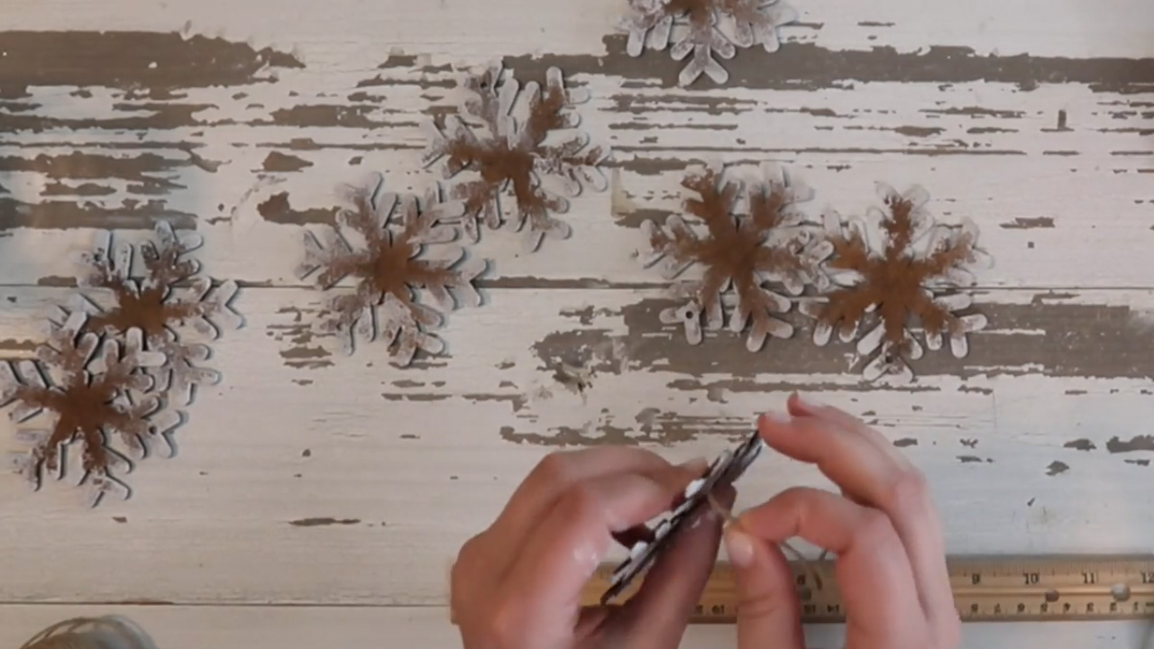 Put the twine hangers in the snowflake carefully