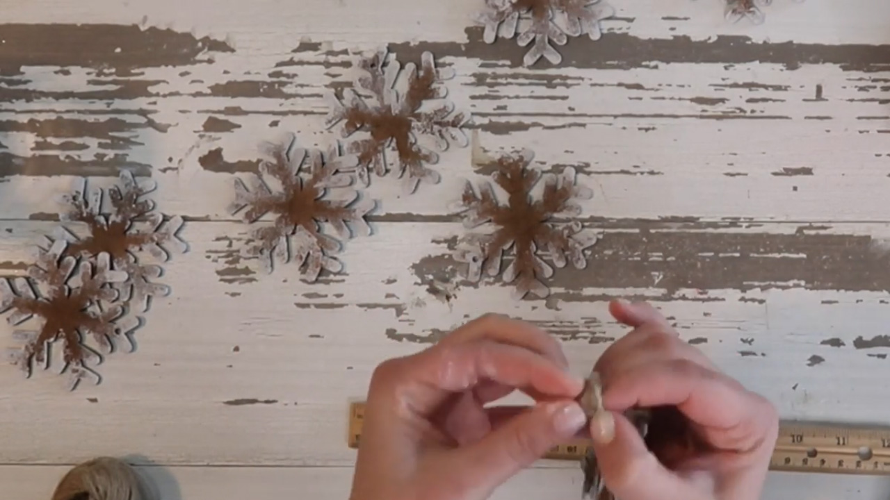 After threading the snowflakes, tie a knot at the end.