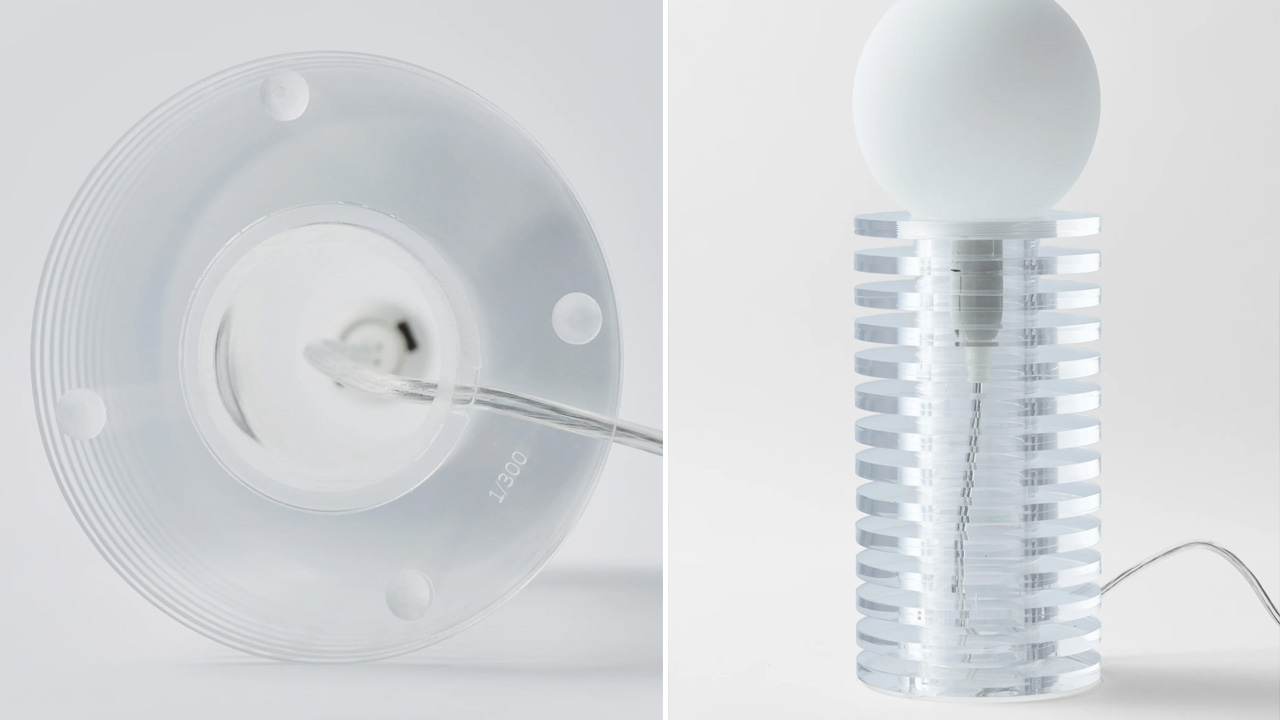 The Lampake table lamp has a cable and . a thin acrylic tube is present in the center holds the discs and spacers together.