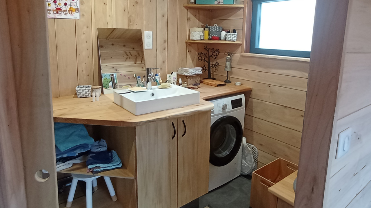 The functional bathroom has a warm and all-wood interior