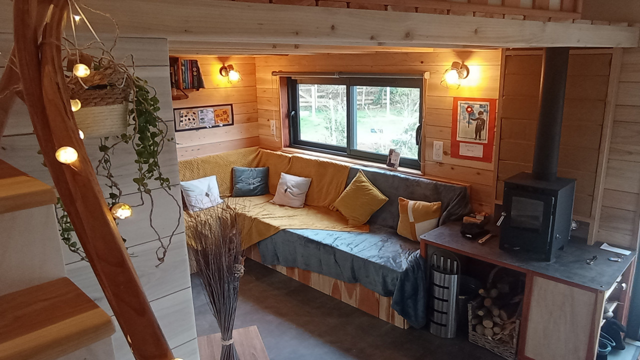 The wood-burning stove gives the living room cozy vibes.