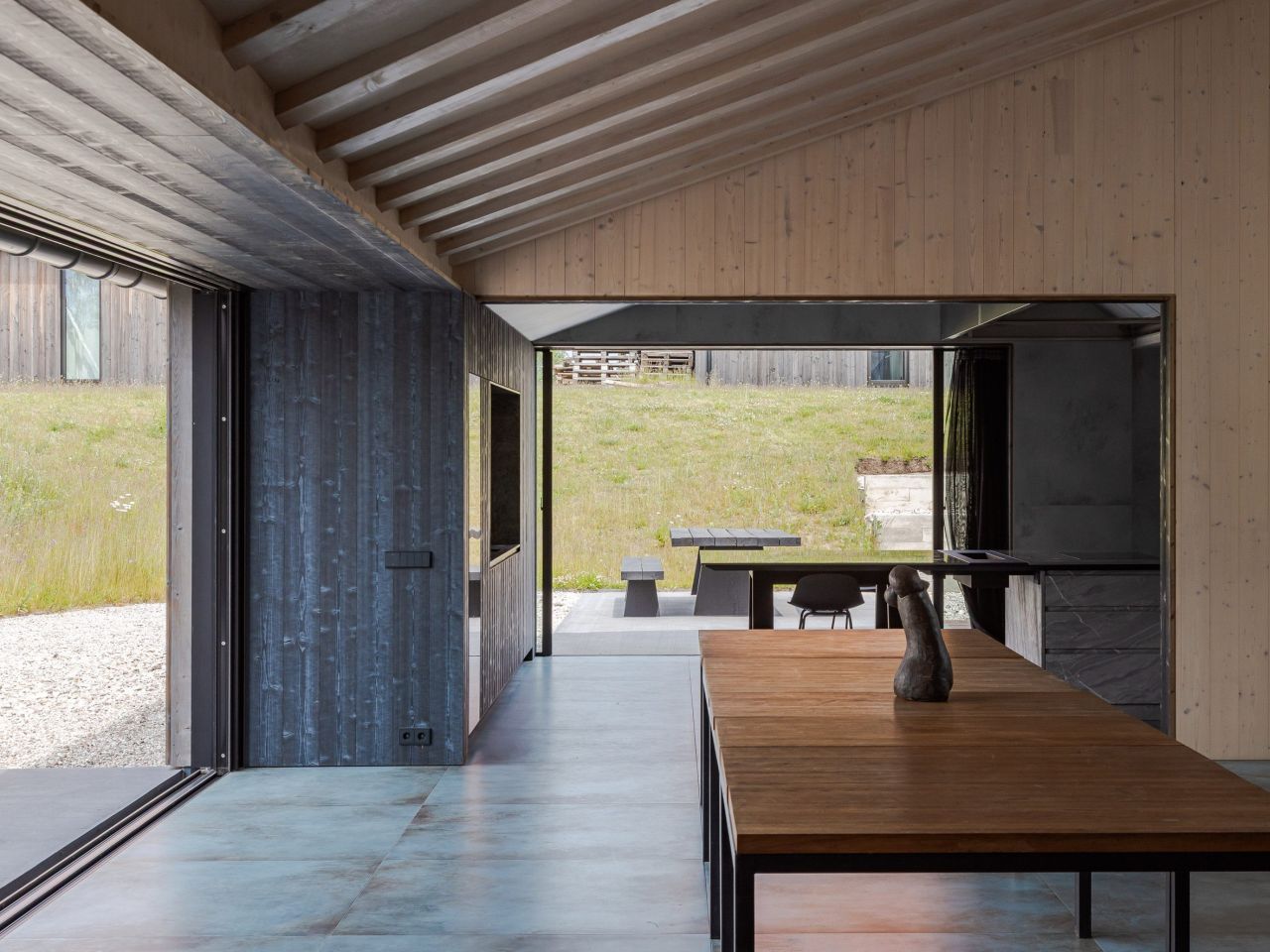 Pāvilosta House’s Curved Slate Roof Looks Like as if it Shaped by Sea Air and Water