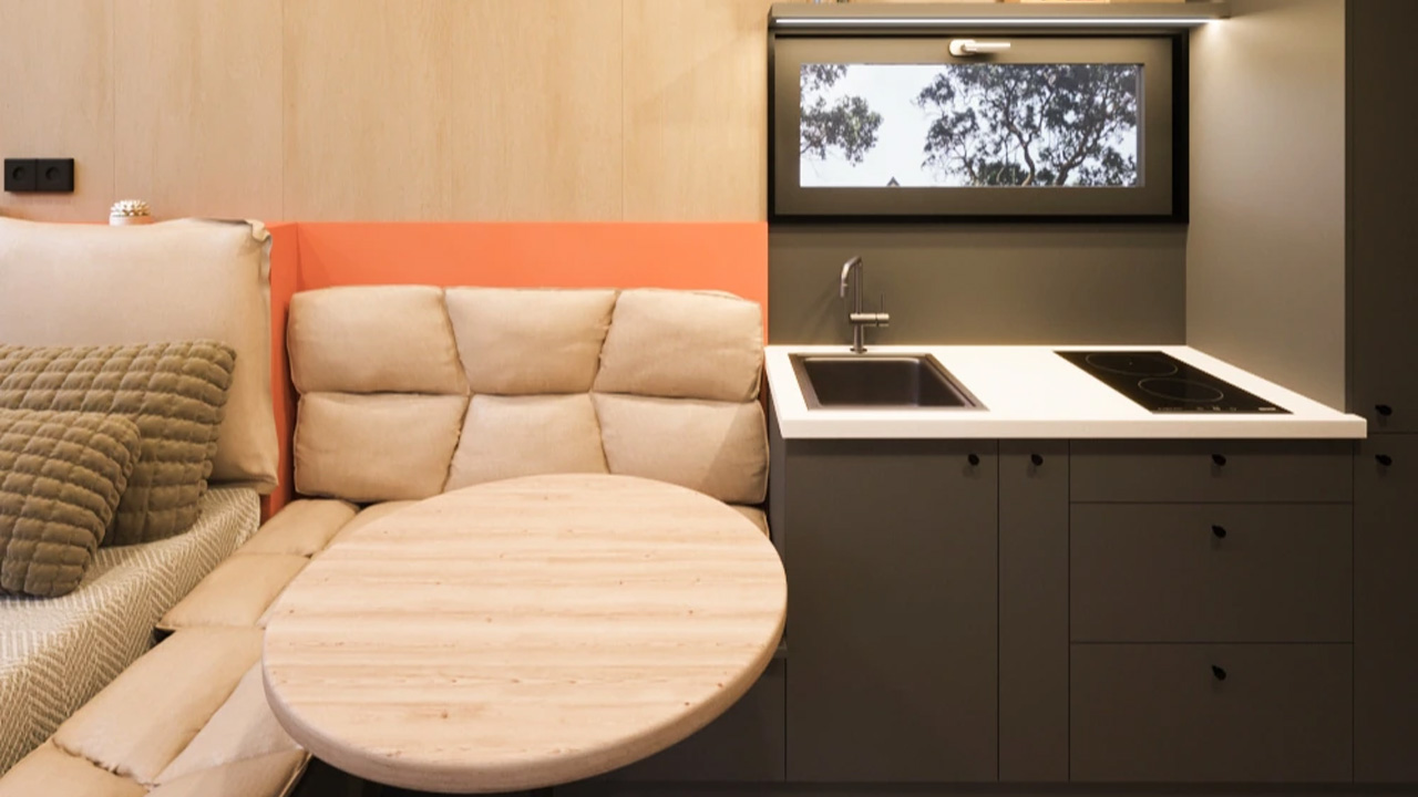 The unique orange accent behind the sofa