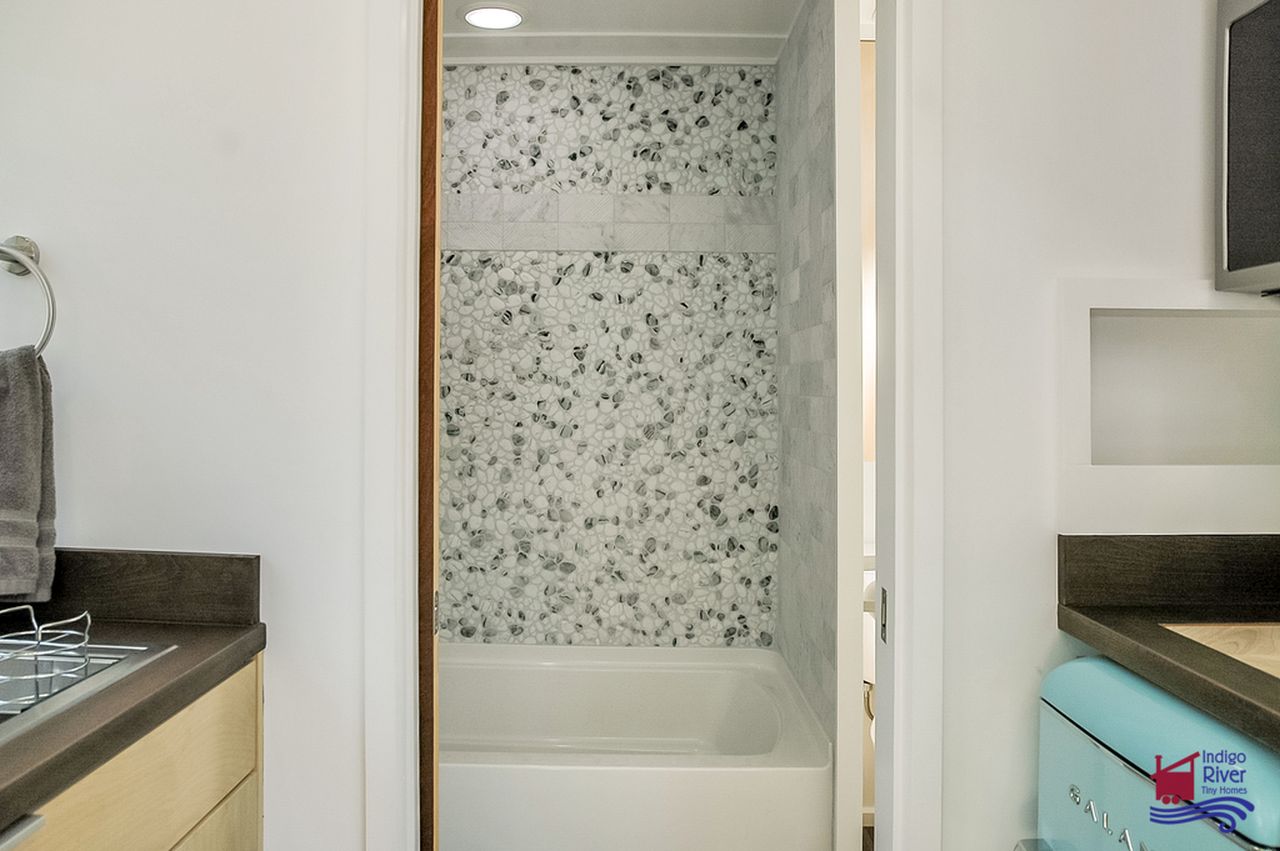 Indigo Go Tiny House Accommodates Everything on a Single Floor - bathtub with shower 