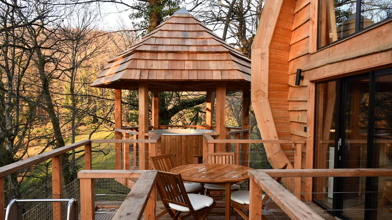 Wooden deck has a tiered layout, joining various zones with each other