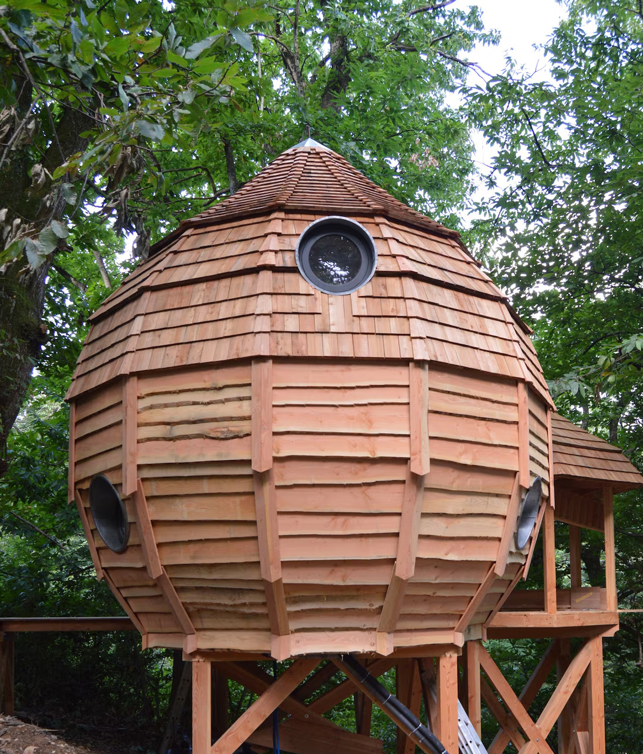 the cabin-style hut has a rounded teardrop shape