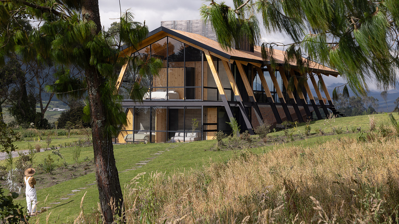 The distinct architecture of the house blends with the rocky terrain
