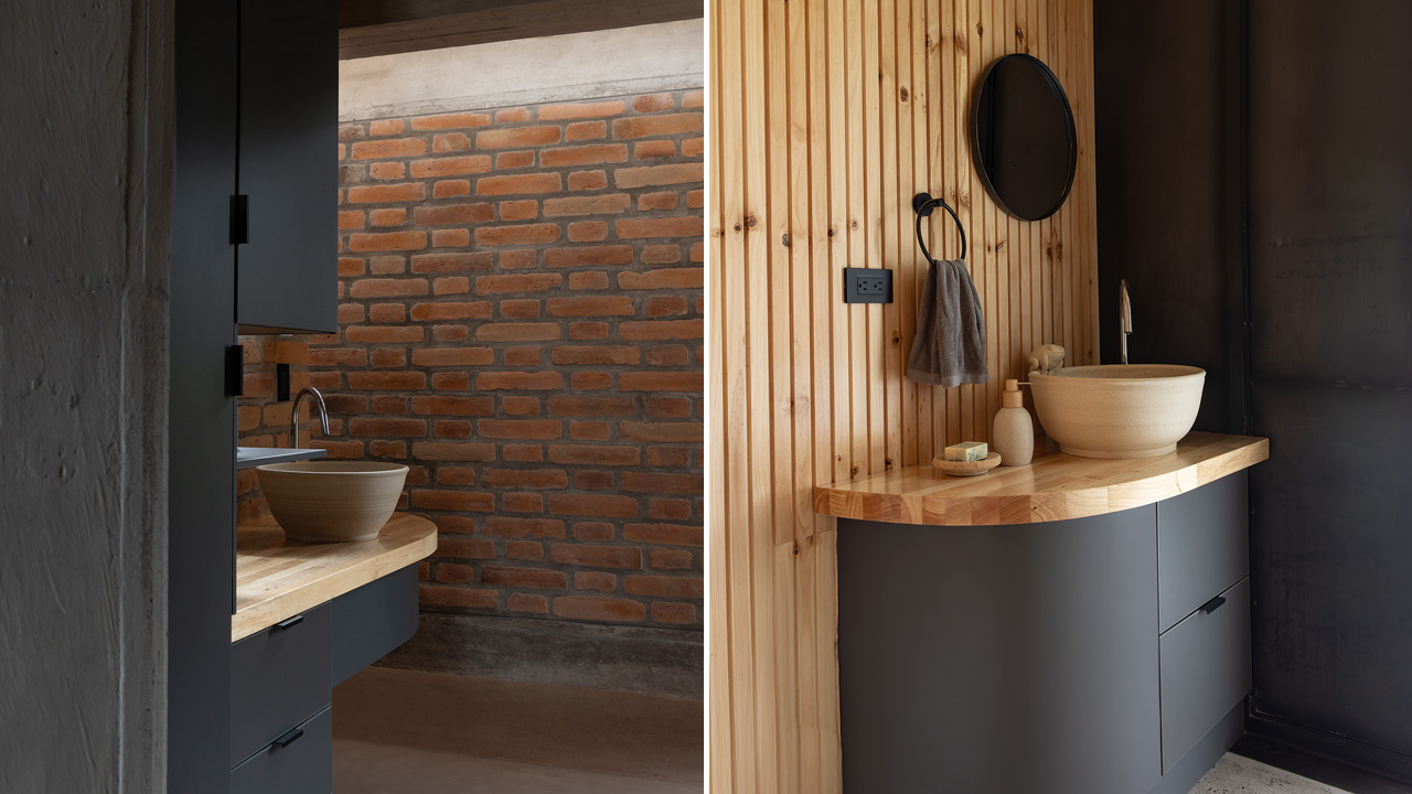 The bathroom features warm woodwork with brick walls