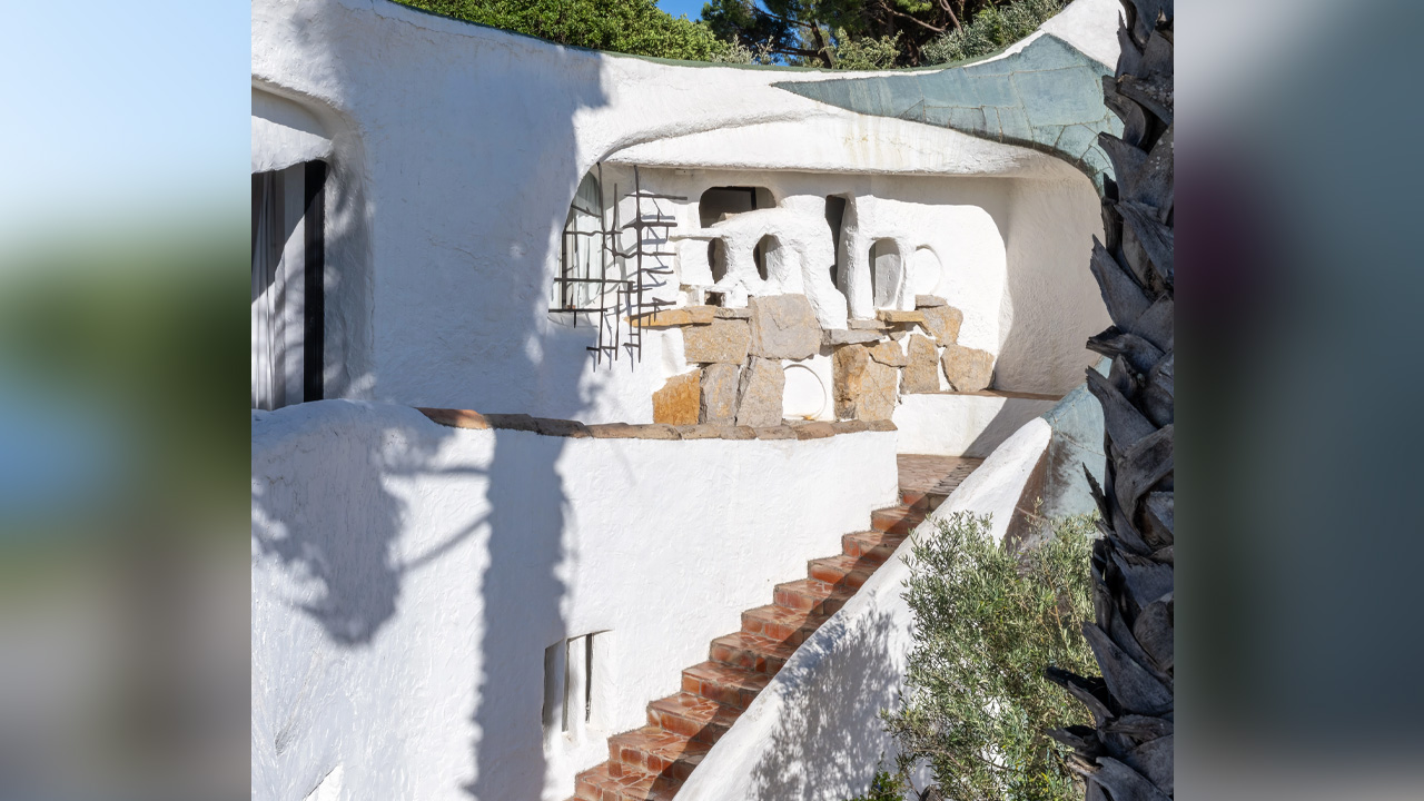 The hand-textured walls and stones make the building look like a part of the landscape
