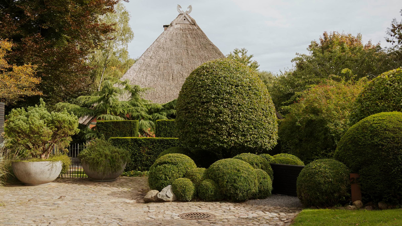 The trimmed shrubs and hedges appear like sculptural objects