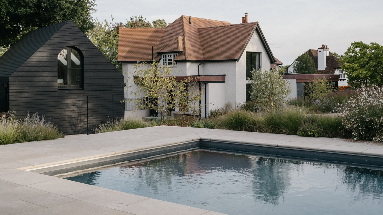 The outbuildings look like sculptural objects placed on the garden