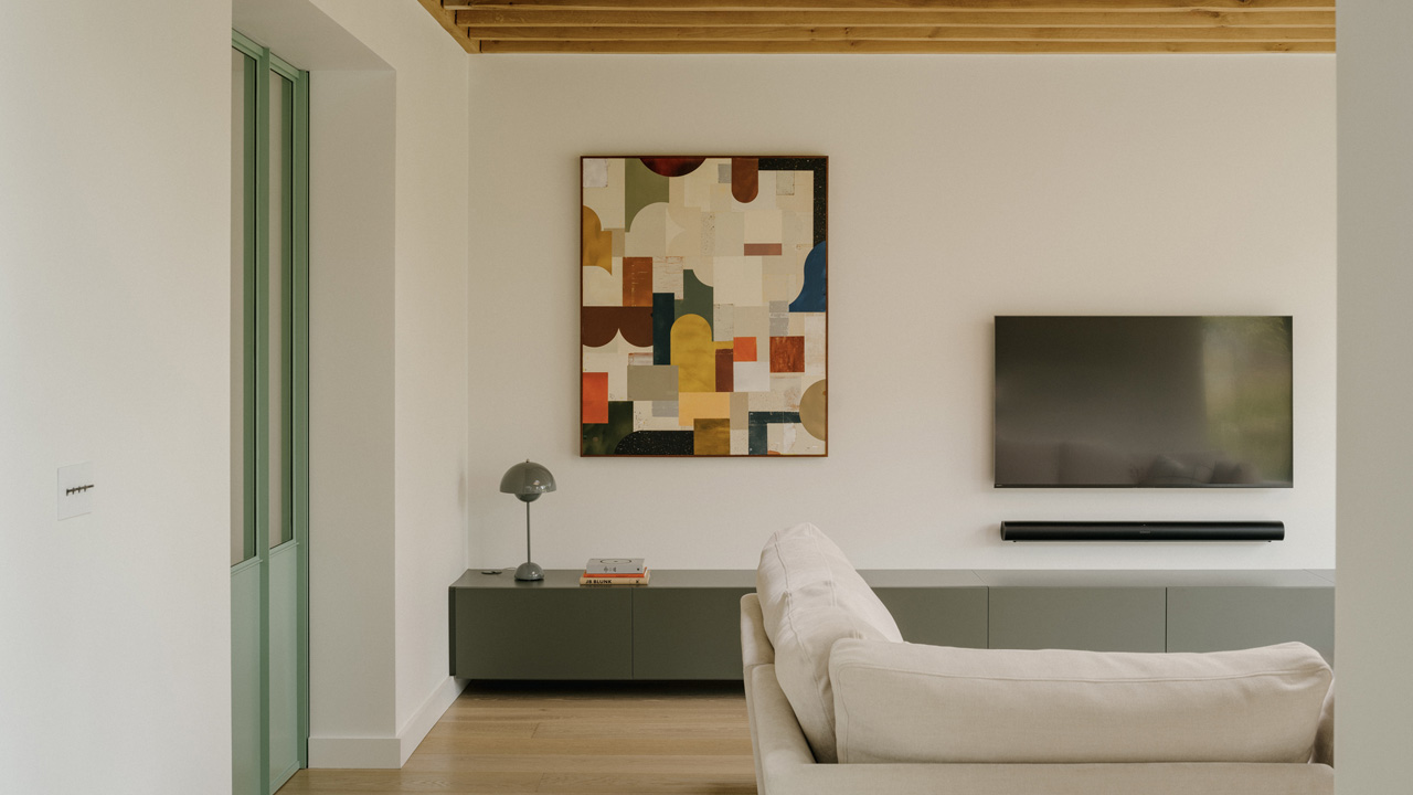 The glazed windows flood the interior of spacious living space with bright light.