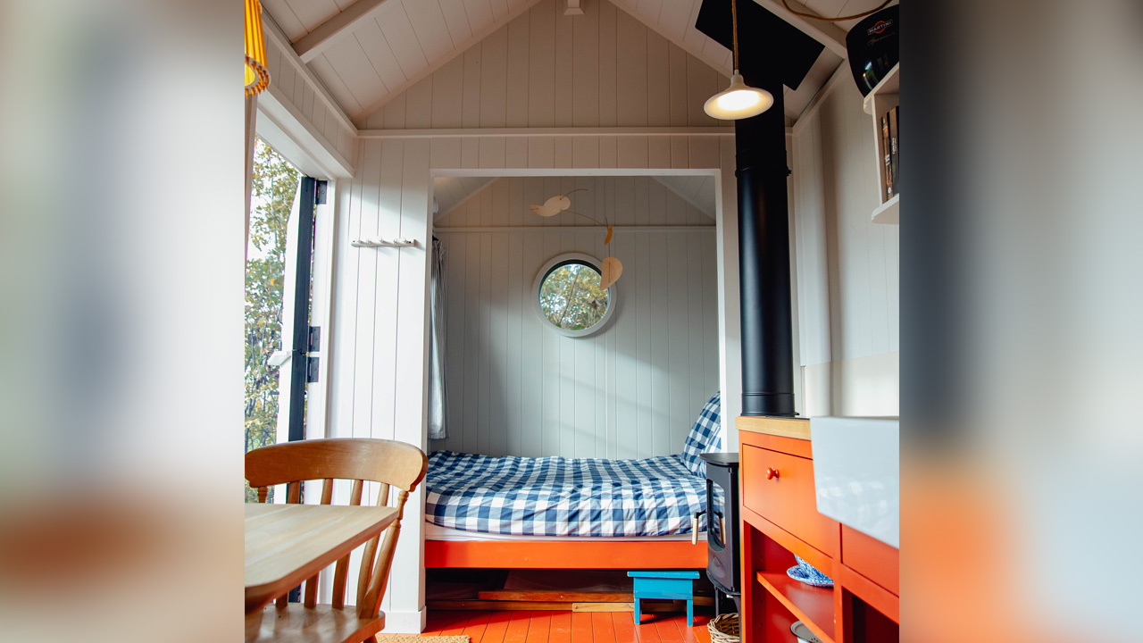 The vivid interior of Tiny Poppy contrasts against the shiplap