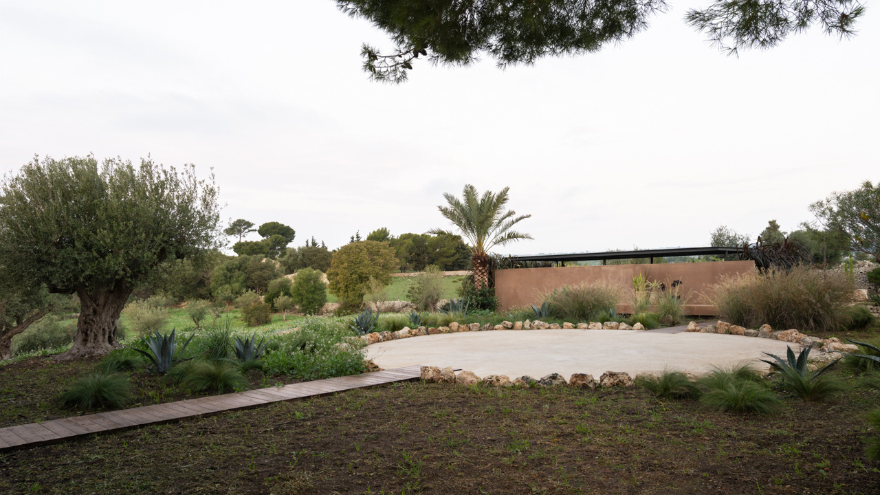 The kiln is a restored stone-drying platform, surrounded by native flora