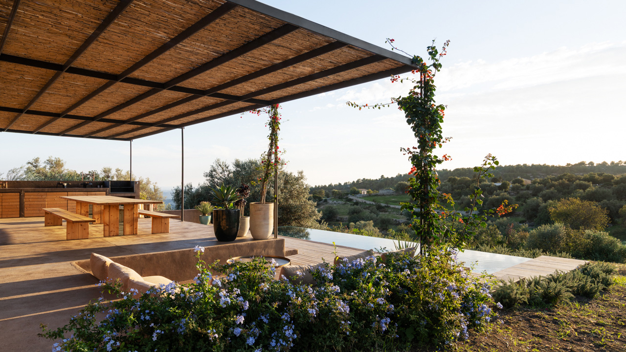 Natural foliage and flowers extension envelop the outdoor terrace and swimming pool