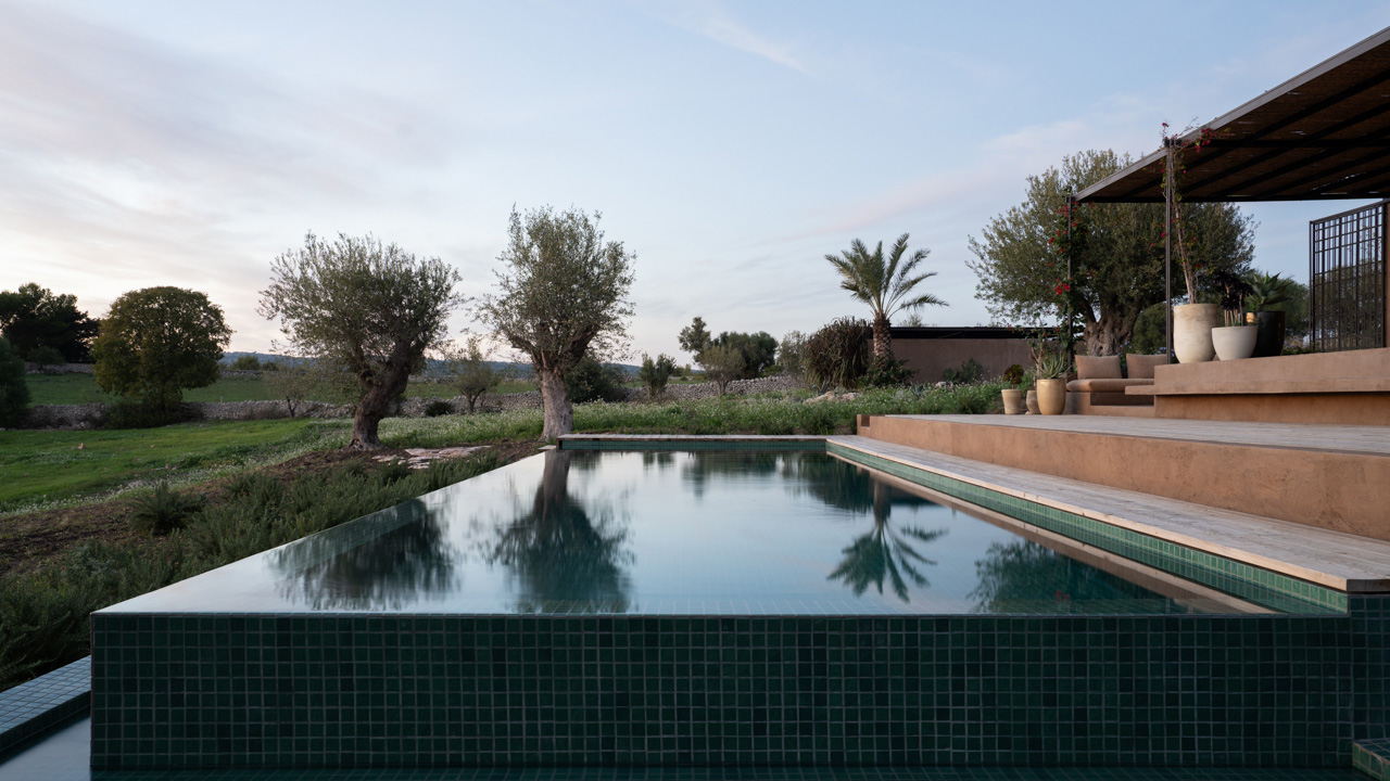 the emerald pool appears like a natural depression with deep green hues