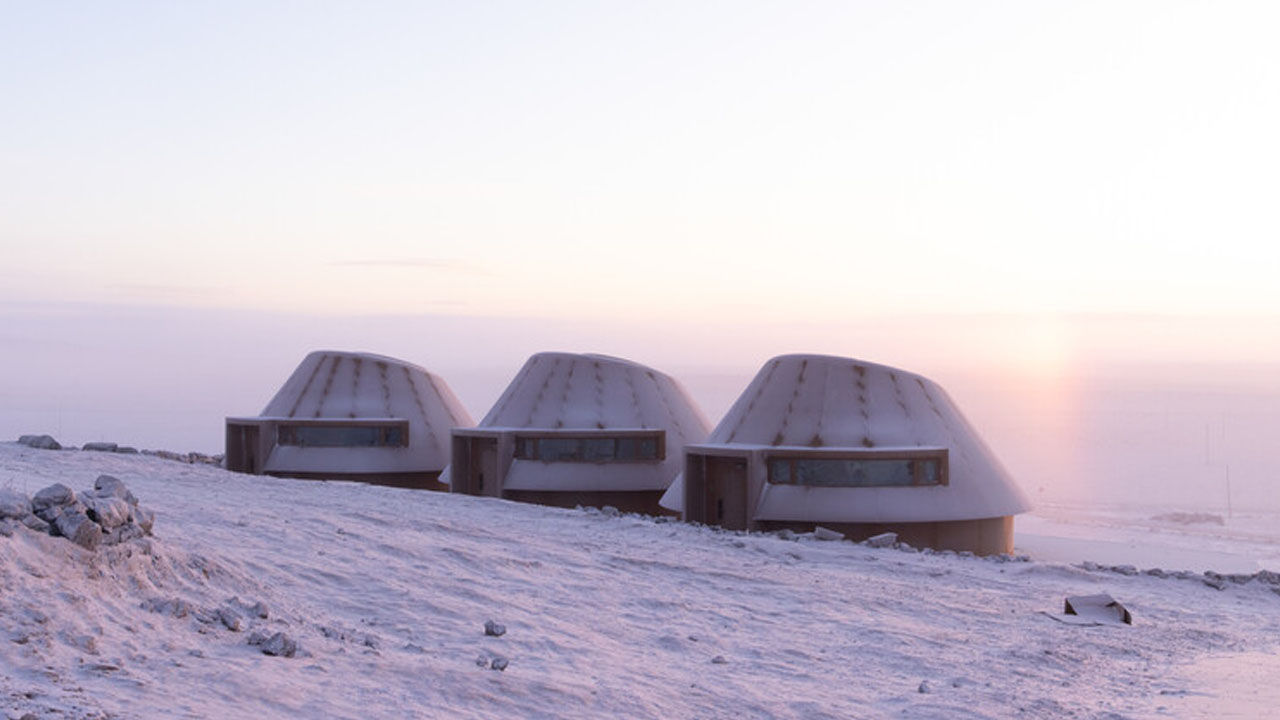 The arrival hotels gradually rise from the volcanic site