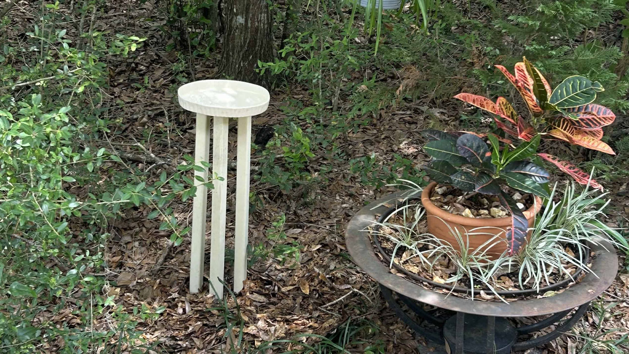 The natural materials add organic charm to the birdbath.