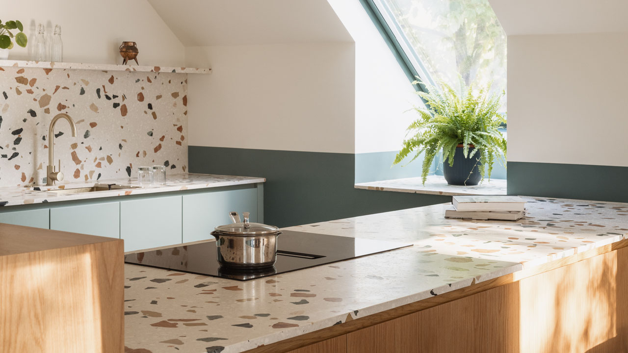 The bold, multi-colored terrazzo countertop and backsplash